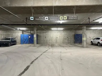 a parking garage with two cars parked in it at Solara 2BR Retreat - Pool - Hot Tub & Resort Perks in Canmore