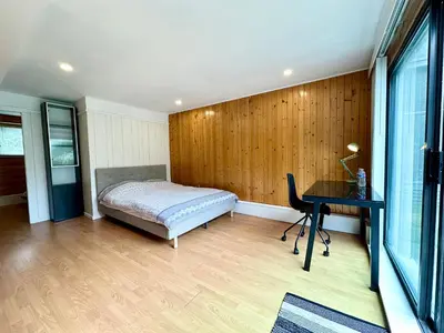 a bedroom with a bed and a desk at Beautiful Place with Kitchen, Washing Machine and Internet Near YVR Airport, Transit and Shopping Mall in Richmond