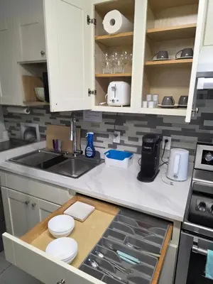 a kitchen with a sink and a counter top at Maplewood Hostel in Vancouver