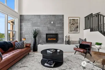 a living room with a couch and a fireplace at Luxurious Detached House with Private Garage, Lake View, Central AC & More in Airdrie
