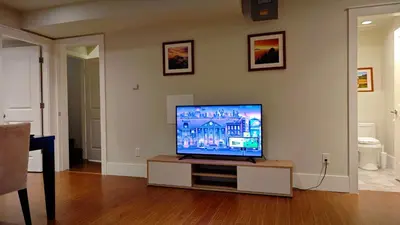 a flat screen tv sitting in a living room at Bright 3-Bedroom Basement Suite with Separate Entrance in Burnaby
