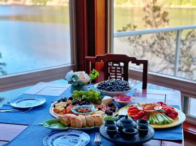 a table with plates of food on top of it at Malahat Fairyland Cottage in Malahat
