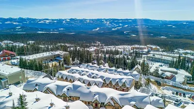 an aerial view of a ski resort with snow covered roofs at Treetops Ski Luxury Townhouse in Big White