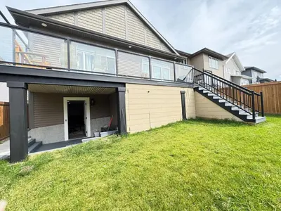 a house with a staircase and a grass yard at Annas Suites Rental in Bélanger
