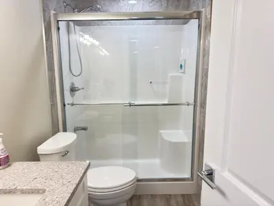a bathroom with a shower with a toilet and a sink at Annas Suites Rental in Bélanger