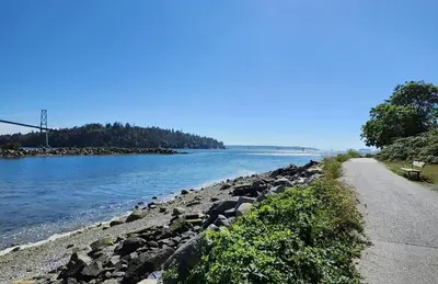 a road next to a body of water at Queens Suite in West Vancouver