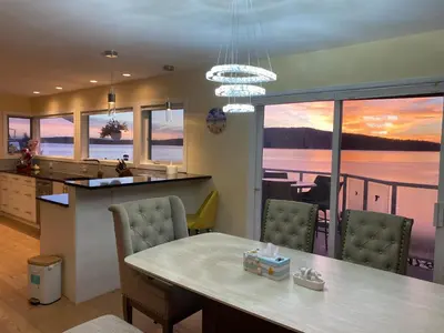 a kitchen and dining room with a view of the ocean at Beachbreeze Panoramic Oceanview 5BR 4BA Romantic Sunrise & Celestial Views in Mill Bay