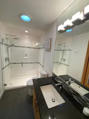 a bathroom with a sink and a shower and a toilet at Beachbreeze Panoramic Oceanview 5BR 4BA Romantic Sunrise & Celestial Views in Mill Bay
