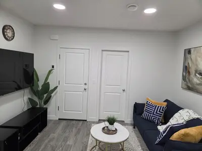 a living room with a blue couch and a table at Modern 2BR near Hospital, YMCA, Stores in Calgary