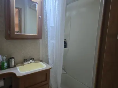 a bathroom with a sink and a shower at Family RV in a farm in Nanoose Bay