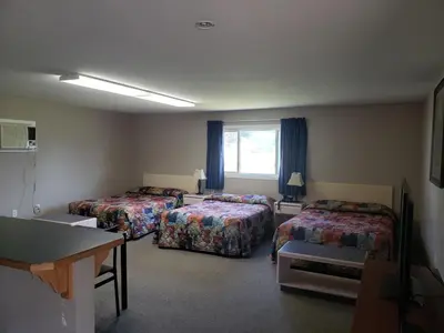 a hotel room with two beds and a window at Lamplighter Inn in Three Hills