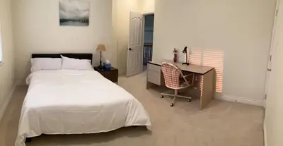 a bedroom with a bed and a desk and a desk at Vancouver Richmond Villa 32 in Richmond