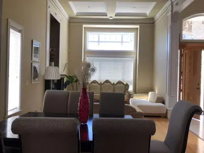 a living room with a couch and a table and chairs at Vancouver Richmond Villa 32 in Richmond
