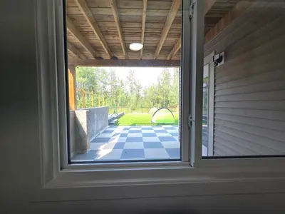 a window in a house looking out at a patio at The Walkout at the Ravine in Edmonton