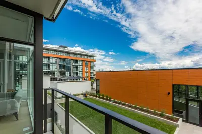 a balcony with a view of a building at Gyro Beach Vacations in Kelowna
