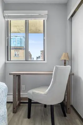 a desk and a chair in a room with a window at YYC HiddenGem in Calgary