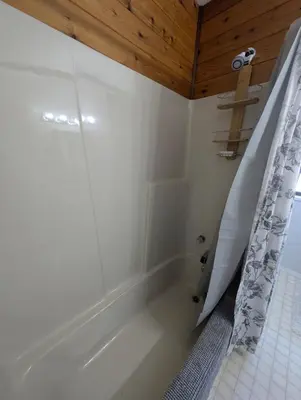 a bathroom with a tub and a shower curtain at Alert Bay, Spacious Executive Suite with Panoramic Ocean Views in Alert Bay