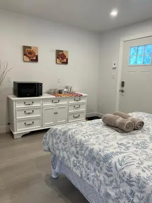 a bedroom with a bed and a microwave at Angie house in Nanaimo
