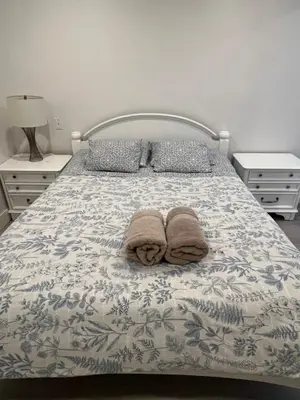 a bedroom with a bed with towels on it at Angie house in Nanaimo