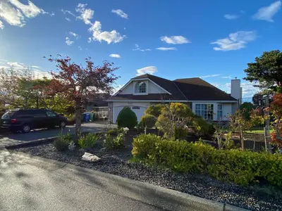 a house with a car parked in the driveway at Angie house in Nanaimo