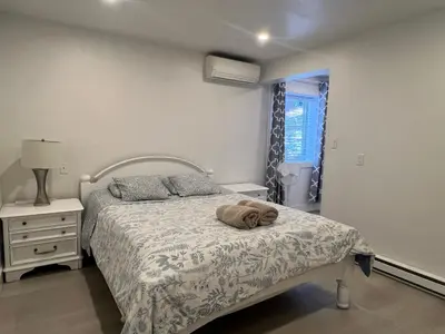 a bedroom with a bed with a towel on it at Angie house in Nanaimo