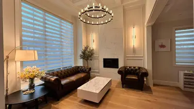 a living room with a leather couch and a table at Vancouver Burnaby Villa 36 in Burnaby