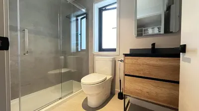 a bathroom with a toilet and a glass shower at Vancouver Westside Villa 37 in Vancouver