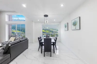 a living room with a table and a couch at Luxury Home in Victoria