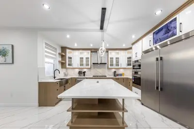 a large kitchen with a large white counter top at Luxury Home in Victoria