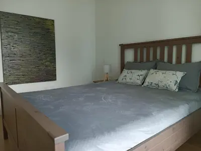 a bedroom with a large bed with a wooden headboard at New condo Great amenities Near Skytrain in Coquitlam