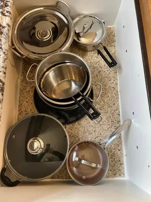 a group of pans sitting on a stove in a drawer at A Gorgeous Mansion for Jasper Vacation in Hinton