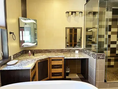a bathroom with two sinks and a shower at A Gorgeous Mansion for Jasper Vacation in Hinton