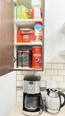 a kitchen counter with a coffee maker and food at Red Deer Stay- 2BR Private Suite in Red Deer