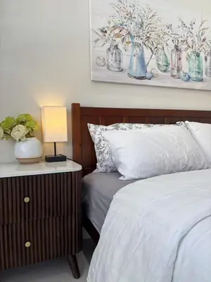 a bedroom with two beds and a table with a lamp at Vancouver Mini Suite in Vancouver