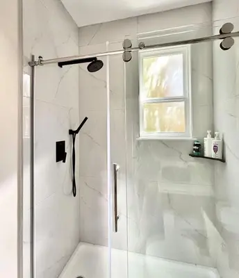 a shower with a glass door in a bathroom at Vancouver Mini Suite in Vancouver