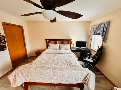 a bedroom with a bed and a ceiling fan at Master Bedroom with attached bathroom in Airdrie