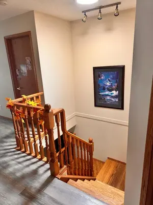 a room with a wooden staircase with a painting on the wall at Master Bedroom with attached bathroom in Airdrie