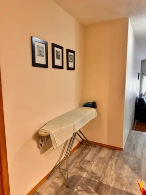 a room with a bench against a wall at Master Bedroom with attached bathroom in Airdrie