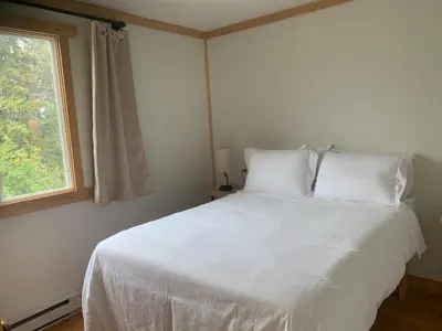 a white bed in a bedroom with a window at Our little heaven Entire house 5 min south of town in Golden