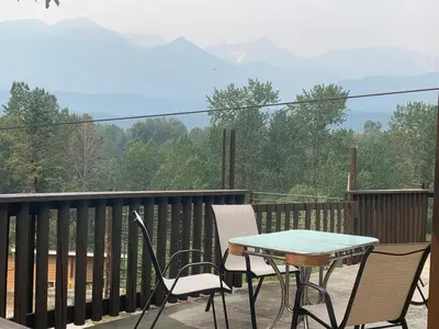 a table and chairs on a balcony with a view of mountains at Our little heaven Entire house 5 min south of town in Golden