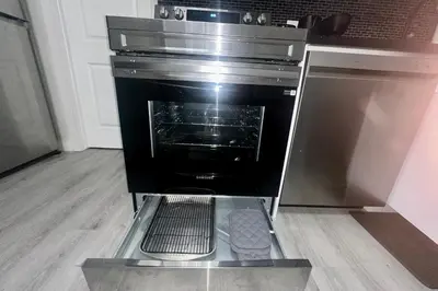 an oven with its door open in a kitchen at Cozy 2BR Retreat - 10 Mins to WEM - Free Parking & WiFi in Edmonton
