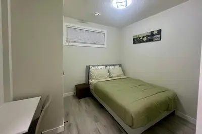 a small bedroom with a bed in a room at Cozy 2BR Retreat - 10 Mins to WEM - Free Parking & WiFi in Edmonton