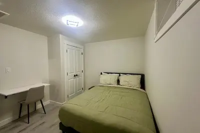 a small bedroom with a bed and a desk at Cozy 2BR Retreat - 10 Mins to WEM - Free Parking & WiFi in Edmonton