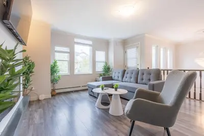 a living room with a couch and chairs and a table at Soothing Minimalist Escape - Suite with Balcony & Fireplace in Vancouver