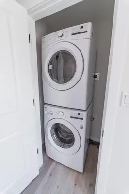 a washer and dryer in a small room at Chic Garden Suite Hideaway 2Bedroom Games Room in Edmonton