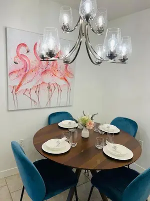 a dining room table with blue chairs and a chandelier at Mordern 2BedRoom Downtown Apt with Free Parking & Wifi in Edmonton