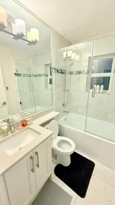 a bathroom with a toilet and a shower and a sink at The Cozy Quad In the Heart of Vancouver in Vancouver