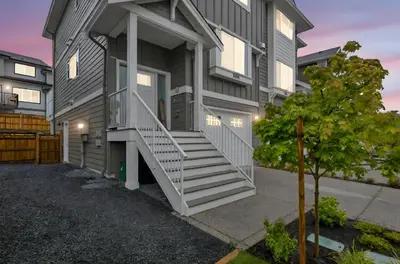 a house with stairs on the side of it at Cozy Langford suite in Langford