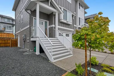 a apartment building with a staircase in front of it at Cozy Langford suite in Langford