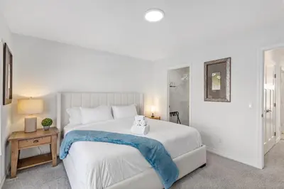 a bedroom with a bed with a teddy bear on it at King Bed, AC, Fenced Yard, Family Friendly, 5 min South Health Campus in Calgary